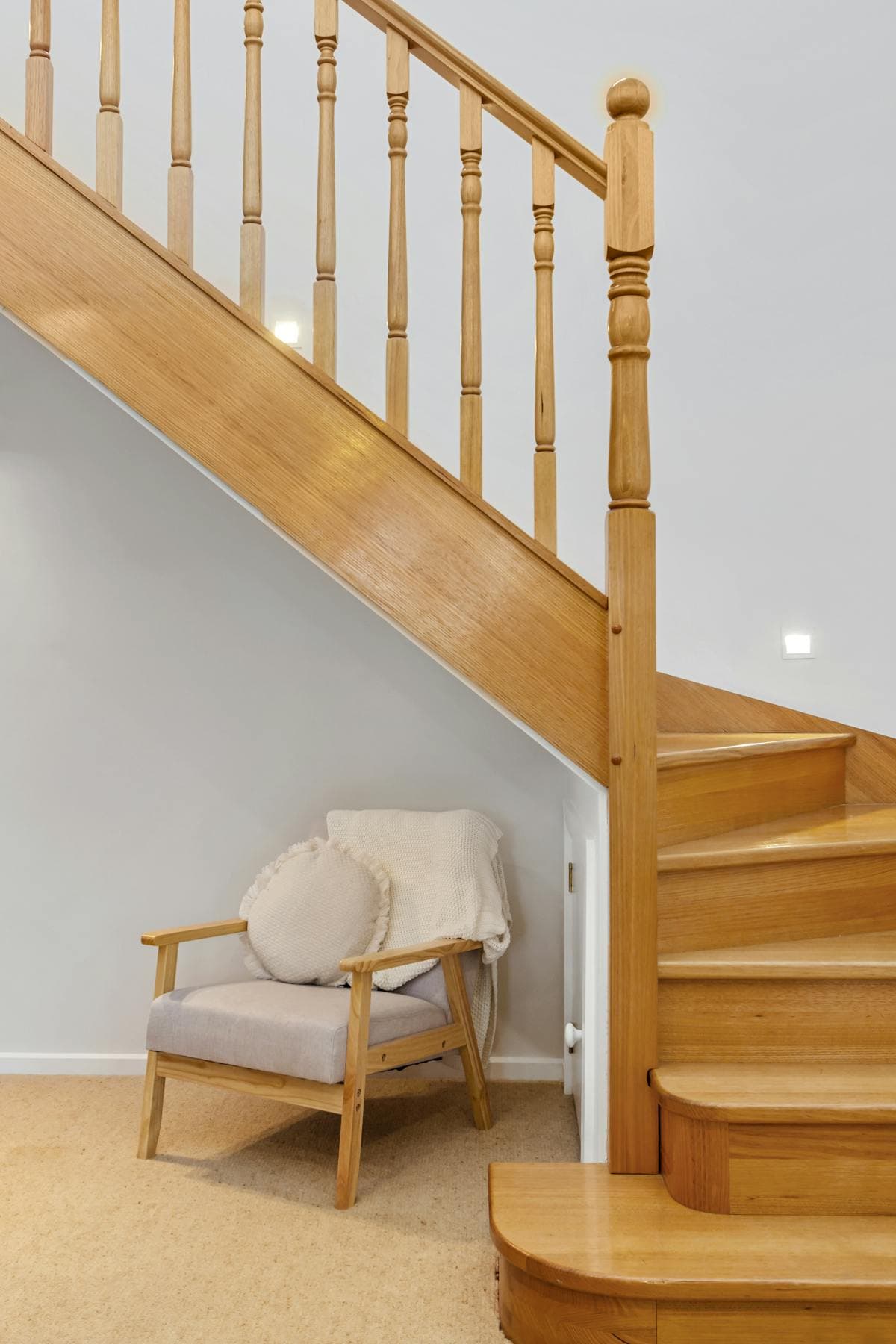 Real-oak staircase with bespoke panelled void converted into a reading nook in Castletown.